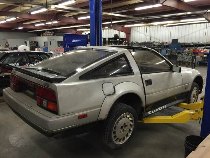 Rear three-quarter view of the 1984 Nissan 300ZX Turbo on the lift