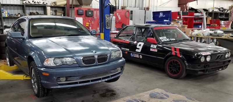 2003 BMW 330Ci alongside the E30 in the shop